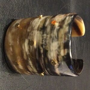 Acrylic 3” mottled cuff bracelet with gold corlored nailheads